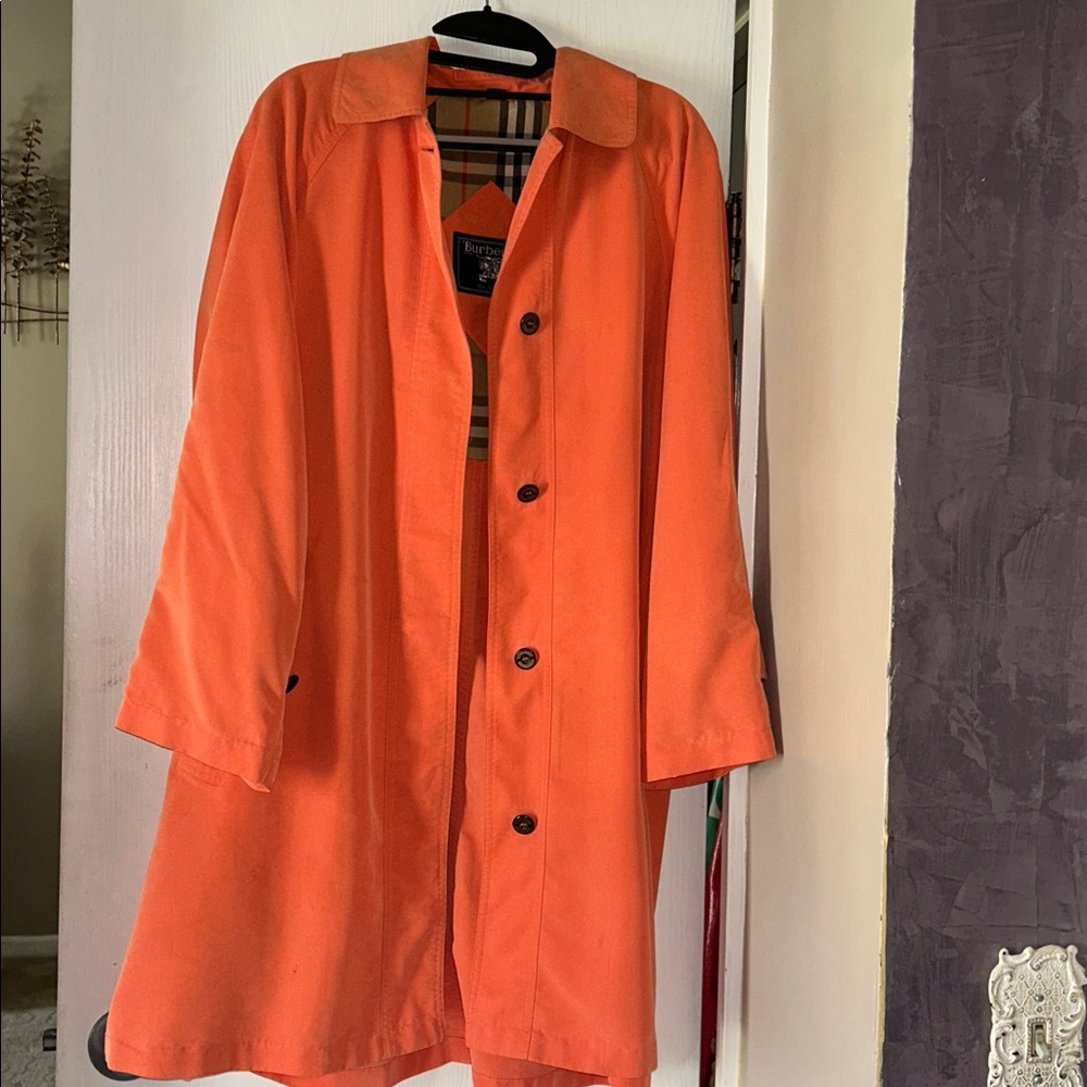 Burberry Coral Lined Trench with Classic Check.  The coat runs large.  It’s M.